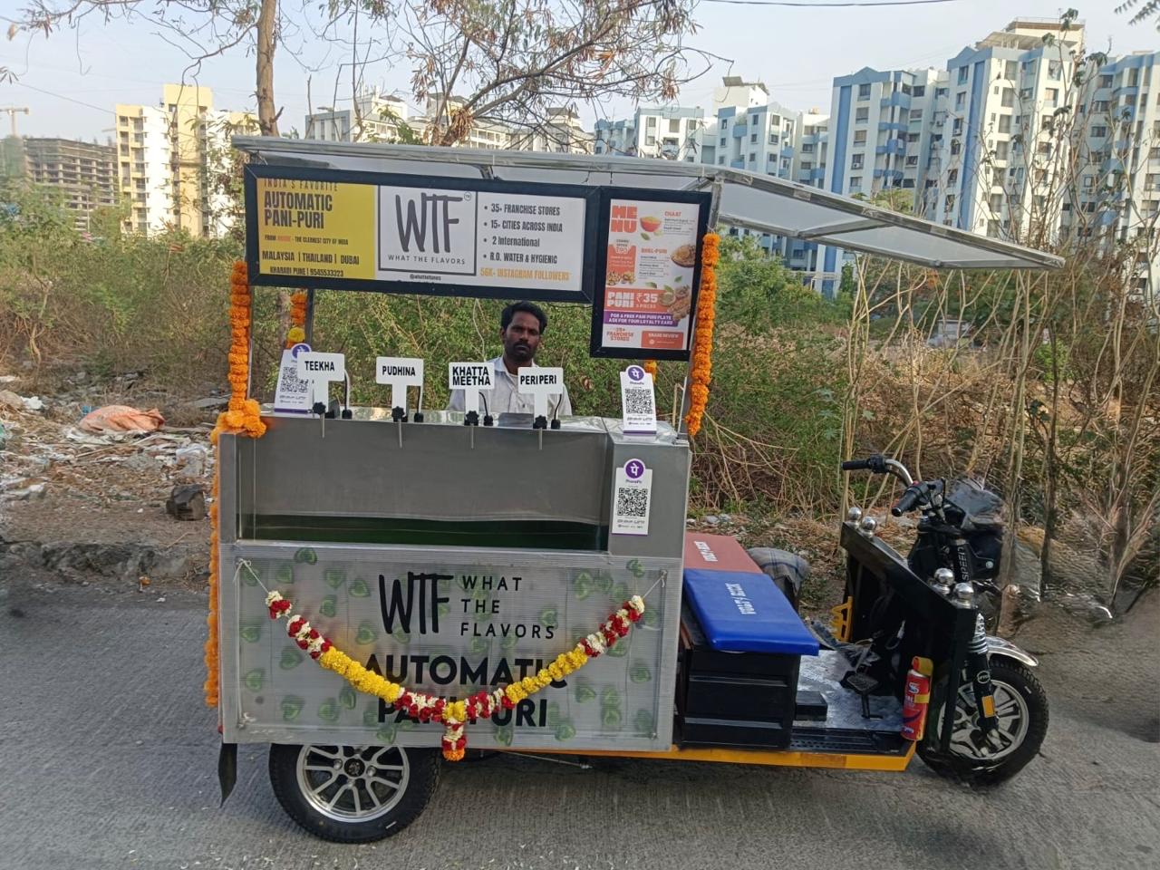 The WTF automatic pani puri cart in Kharadi, Pune — four paani flavours on the counter
